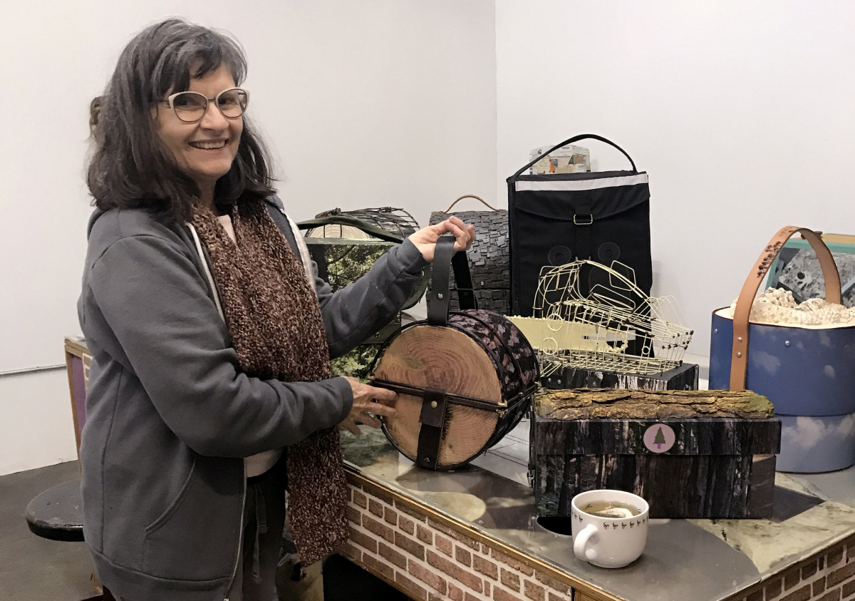 Artist Kim Abeles with valises from the project.