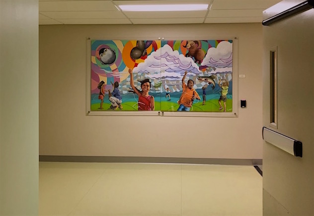 Kelsey Sletto’s playful and bright mural greets you as you walk through a hospital hallway.