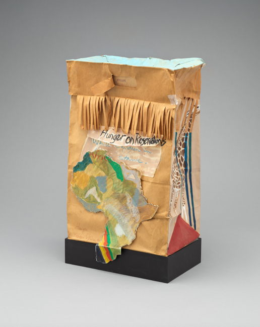 A mixed media work on a paper bag showing the continent of Africa and the words 'Hunger on Reservations' visible.