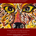 Cover of a conference program book featuring a painting of a wolf's face created with dynamic brushstrokes in reds and yellows. 