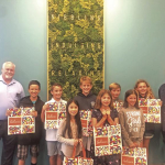 Students pictured holding Gelson's shopping bags that feature their designs.