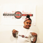 Student a part of Windows of Hip Hop program pictured with banner.