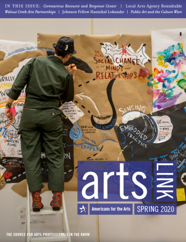 The cover of the Spring issue of Arts Link, depicting a person in a green jumpsuit standing on a ladder marking on a poster-lined wall.