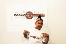Student a part of Windows of Hip Hop program pictured with banner.